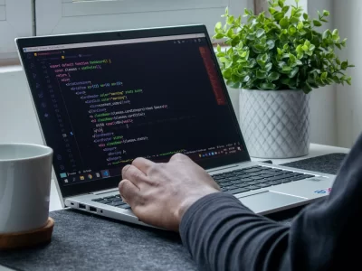 view of a person programming on a laptop